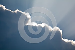 Sun rays shinning through a dark cloud