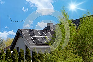 Sun rays and solar panels. Beautiful, contemporary house with a gable roof