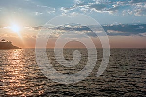 Sun rays sunset reflected in the sea and sky