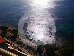 Sun reflected in the waves of the Caribbean sea coastline malecon Santo Domingo