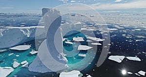 Sun reflection at arctic ocean with melt iceberg aerial. Environment ecological issue of global warm