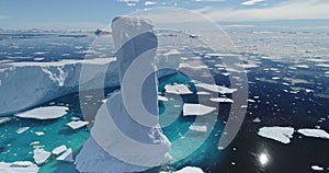 Sun reflection at arctic ocean with melt iceberg aerial. Environment ecological issue of global warm