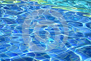 Sun reflection on the blue clear water ripples of pool abstract background