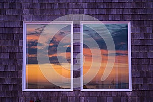 The sun reflects itself in the windows of beachfront homes in the pacifi coast; beautiful, dramatic skies and colors; golden light