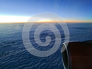 Sun rise from above the cloud from window seat of airplane