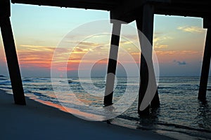 The sun rise, as seen from under the pier