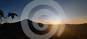 sun rise behind the mountain