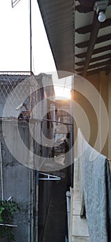 The sun rises through the dense buildings