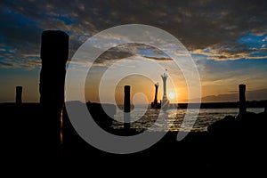 The sun rises on an old town pier