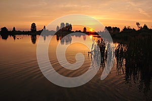 Sun rises at Tsnyanskoe reservoir Minsk Belarus