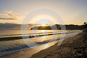 Sun Rising Above Dunes in Ponta Negra Beach