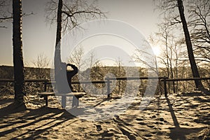 sun rising in heavy snow covered forest - vintage retro look