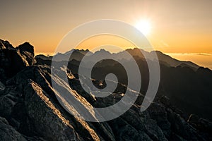 Sun rising over the beautiful mountains and clouds in High Tatras, Slovakia