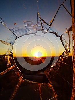 Sun rising over the countryside, viewed through a broken window - Uruguaiana, Brazil