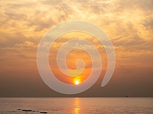 Sun is rising over horizon line with sea view and colorful sky