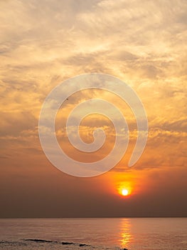 Sun is rising over horizon line with sea view and colorful sky