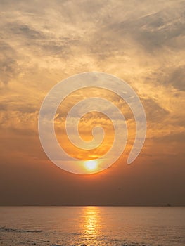 Sun is rising over horizon line with sea view and colorful sky