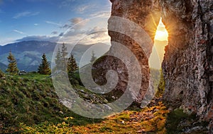 Sun in rock window at sunset landscape