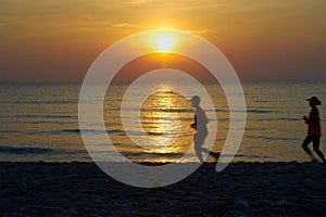 Sun set at beach with running people silhouette