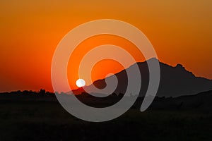 Sun set behind the Aravalli mountain ranges photo