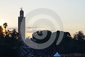 Sun set with Kutubiyya mosque minaret and Jemaa el-Fna in Marrakesh in Morocco