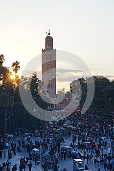 Sun set at Kutubiyya mosque minaret and Jemaa el-Fna in Marrakesh in Morocco - vertical