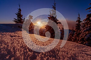 Sun set in mountains with winter and cold scenery