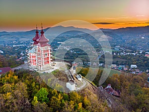 Sun set in old town with historical cityspace buildings in Banska Stiavnica, Slovakia, UNESCO, Aerial photo of calvary.