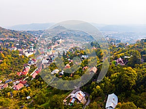 Sun set in old town with historical cityspace buildings in Banska Stiavnica, Slovakia, UNESCO, Aerial photo of calvary.