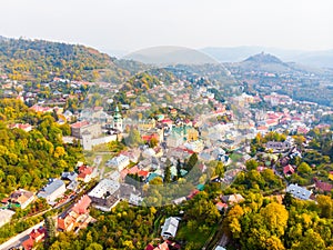 Sun set in old town with historical cityspace buildings in Banska Stiavnica, Slovakia, UNESCO, Aerial photo of calvary.