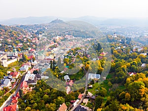 Sun set in old town with historical cityspace buildings in Banska Stiavnica, Slovakia, UNESCO, Aerial photo of calvary.