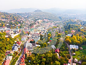 Sun set in old town with historical cityspace buildings in Banska Stiavnica, Slovakia, UNESCO, Aerial photo of calvary.