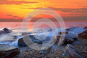 Sun set at rock sea beach