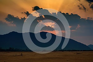 Sun settin behind Eastern Ghat Mountain range over Mahanadi river, copy space