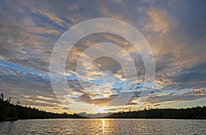 The Sun Setting Amidst High Clouds