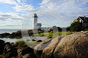 Sun setting by Annisquam lighthouse in Massachusetts