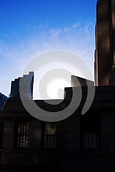 Sun setting behind buildings