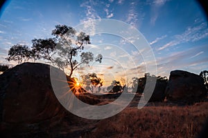 Sun setting behind granite boulders in outback Australia