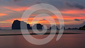 Sun setting behind the hilly islands and cliffs