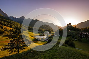 Sun is setting at the mountains surrounding TaraspGraubÃ¼nden, Switzerland