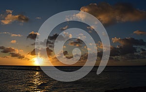 Sun Setting Near the Horizon with Dark Clouds