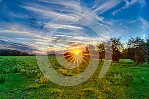 Sun setting over country farm land in york south carolina