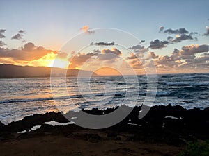 Sun setting over Hawaii coastline