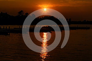 Sun Setting Over a Lake with Docks on the Water