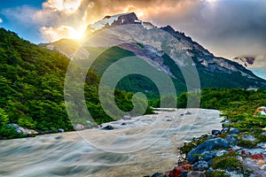 Sun is setting over the mountains and Fitz Roy river at Los Glaciares National Park photo