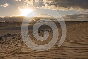 Sun setting over the mountains In the Natural Park Corralejo Fuerteventura Canary Islands Spain