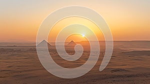 The sun is setting over the pyramids of Egypt