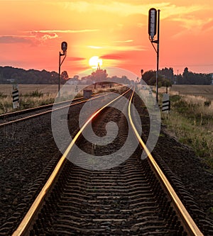 Sun is setting over the railroad tracks