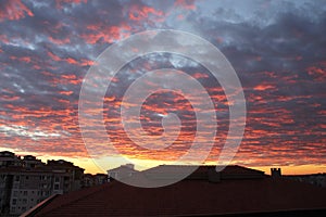 sun setting over roofs