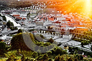 Sun setting over a traditional Norwegian neighborhood. View over a beautiful city in Norway with many houses and streets during su